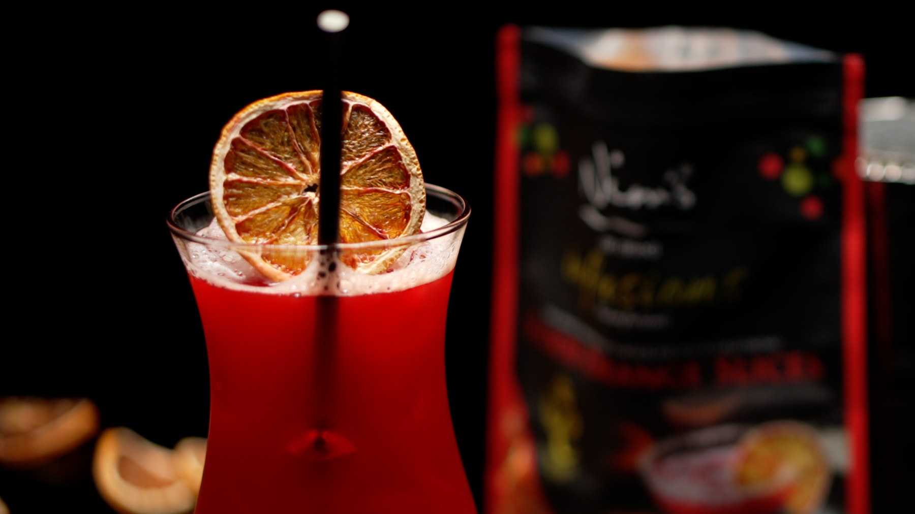 Dark red Negroni cocktail garnished with a dried orange slice — Nim's ...naturally